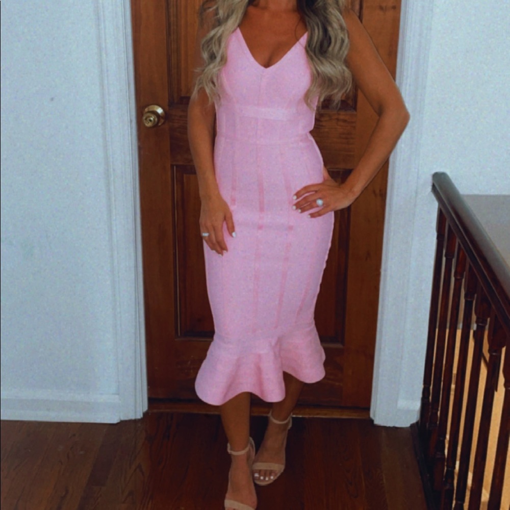 Pink fitted midi dress with a flare at the bottom